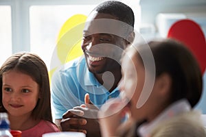 Teacher Supervising Children Eating School Lunch photo