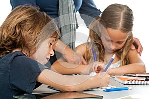 Teacher supervising kids homework. photo