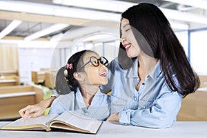 Teacher talking with student while teaching