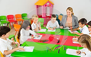 Teacher talking to children in classroom