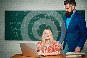 Teacher teaches a student. School day. Science and education concept. Teacher and student sit together at education