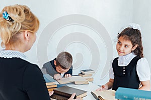 Teacher teaching children at school in lesson