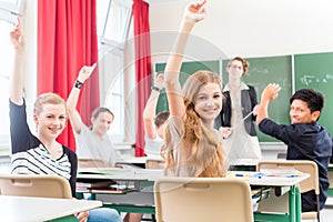 Teacher teaching a class of pupils in school