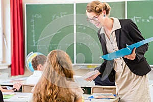 Teacher teaching a class of pupils in school