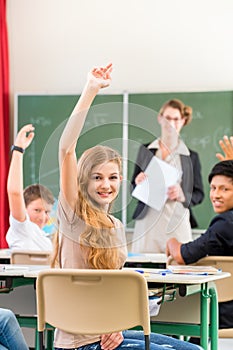 Teacher teaching a class of pupils in school