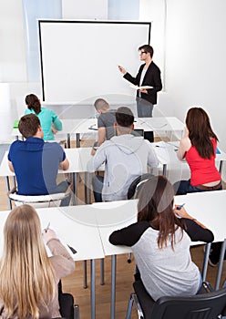 Teacher Teaching College Students In Classroom