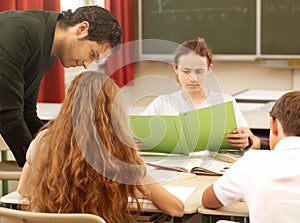 Teacher teaching or educate at the board a class in school