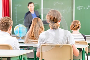 Teacher teaching or educate at the board a class in school