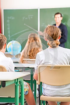 Teacher teaching or educate at the board a class in school photo