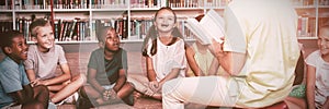 Teacher teaching kids in library photo