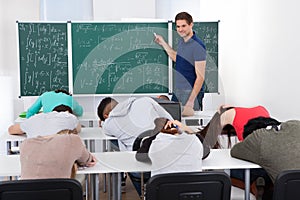 Teacher teaching mathematics to bored students