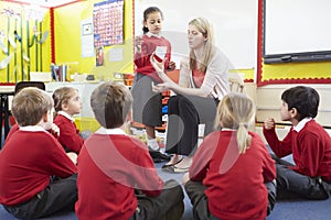 Teacher Teaching Maths To Elementary School Pupils