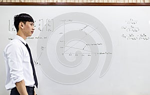 Teacher is teaching physics to students during the new school days after a long break, High school student classroom