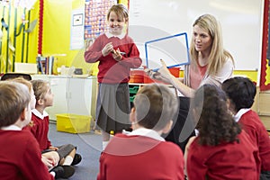 Teacher Teaching Spelling To Elementary School Pupils