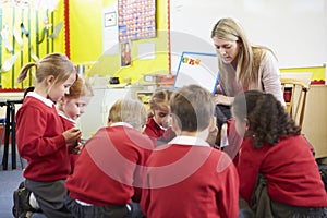 Teacher Teaching Spelling To Elementary School Pupils