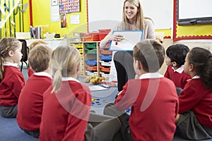 Teacher Teaching Spelling To Elementary School Pupils photo