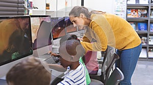 Teacher teaching student in computer room