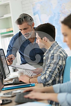 Teacher with trainees in computing class