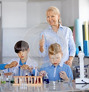 Teacher and Two laboratory assistants kids