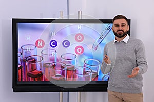 Teacher using interactive board in classroom during lesson