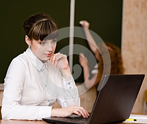 Teacher using a laptop computer at school