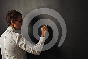 Teacher in white blouse at the blackboard