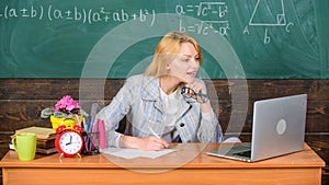 Teacher woman sit table work laptop surfing internet chalkboard background. Organize class and make learning easy