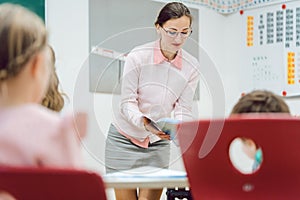Teacher woman talking to student in class room