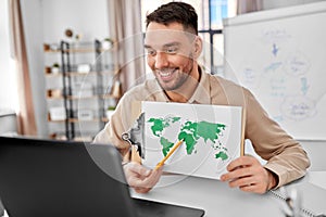 teacher with world map having online class at home