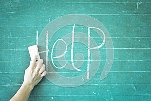Teacher writes help on blackboard