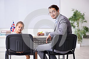 Teacher with young girl in the classroom