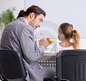 Teacher with young girl in the classroom