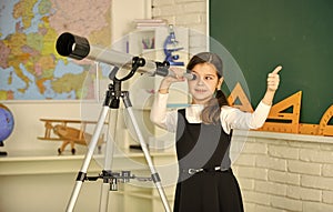 Teachers day. Little girl using telescope. Telescope on tripod. School subjects set. School astronomy lesson. Exploring