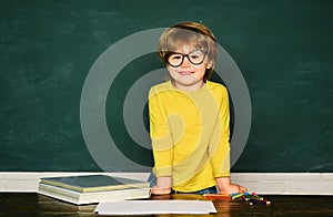 Teachers day. Schoolkid or preschooler learn. Science education concept. Cheerful smiling child at the blackboard. photo