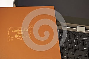 Teachers gradebook on top of laptop computer
