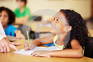 Teaching, child writing and hand of teacher helping student at school for education, learning or development. Woman with