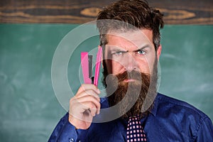 Teaching memorization techniques. Back to school and studying. Teacher bearded man with pink stapler chalkboard photo