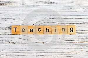 TEACHING word made with wooden blocks on the table