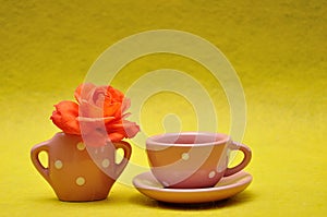 A teacup with an orange rose