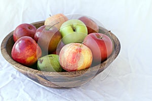 A teak bowl of homegrown apples and pears.
