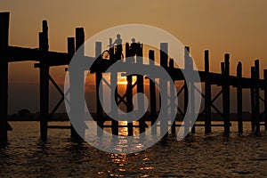 Teak bridge U Bain in Burma. Sunset, silhouettes.