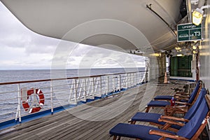 Teak lined Promenade Deck of modern cruise ship