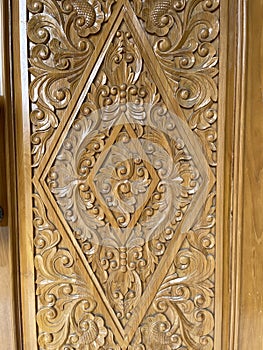 Teak wood door with floral motif carvings