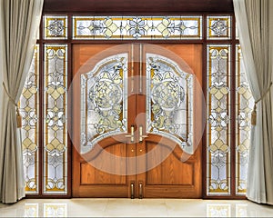 Teak wooden door with frosted glass interior.