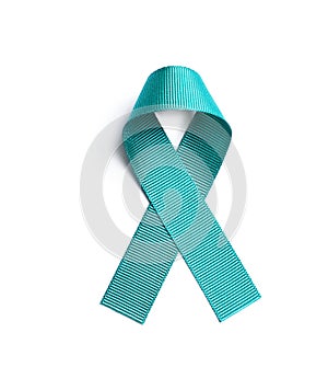 Teal awareness ribbon on white background, top view. Symbol of social and medical photo