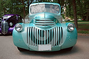 Teal hot rod car at a car show.