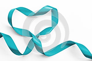 Teal ribbon awareness in heart shape isolated on white clipping path symbolic bow color for Ovarian Cancer, PCOS disease