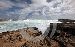 Teal storm waves crashing into Laie Point on the North Shore of Oahu Hawaii United States