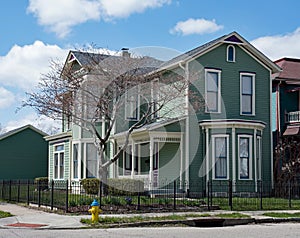 Teal Victorian Corner House with Purple Accents