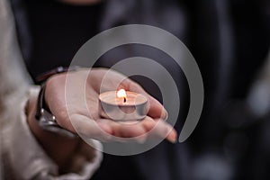 Tealight being held in the palm of a hand at a vigil in England